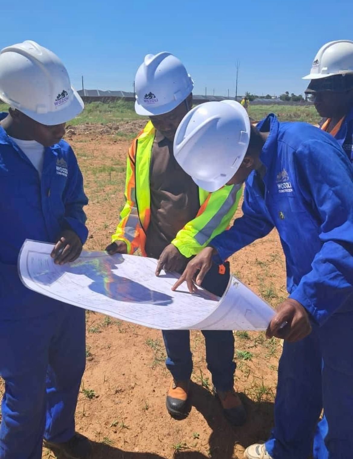 Wozoli engineers reviewing drawings at site setting-out